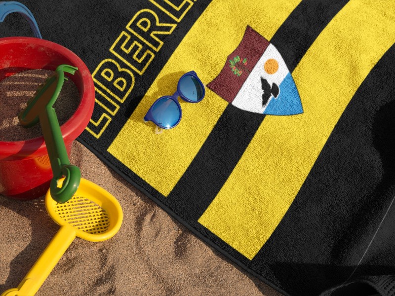 mockup-of-a-towel-lying-on-the-beach-with-accessories-near-it-and-sunglasses-a14892